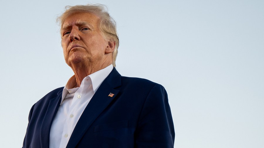 Former President Trump looks on during a rally