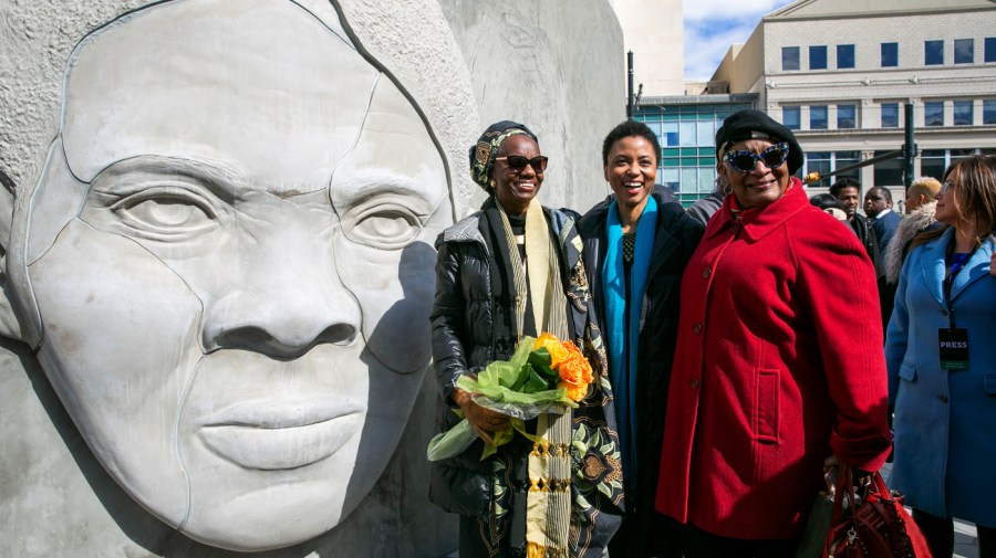 Architect Nina Cooke John (center) stands with the Harriet Tubman monument she designed