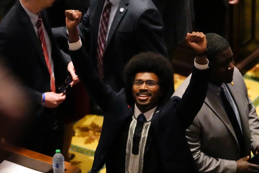 Rep. Justin Pearson, D-Memphis, raises his fists on the floor of the House chamber to recognize his supporters before the start of the legislative session Thursday, April 6, 2023, in Nashville, Tenn. Tennessee Republicans are seeking to oust Pearson, and two other House Democrats for using a bullhorn to shout support for pro-gun control protesters in the House chamber. (AP Photo/George Walker IV)