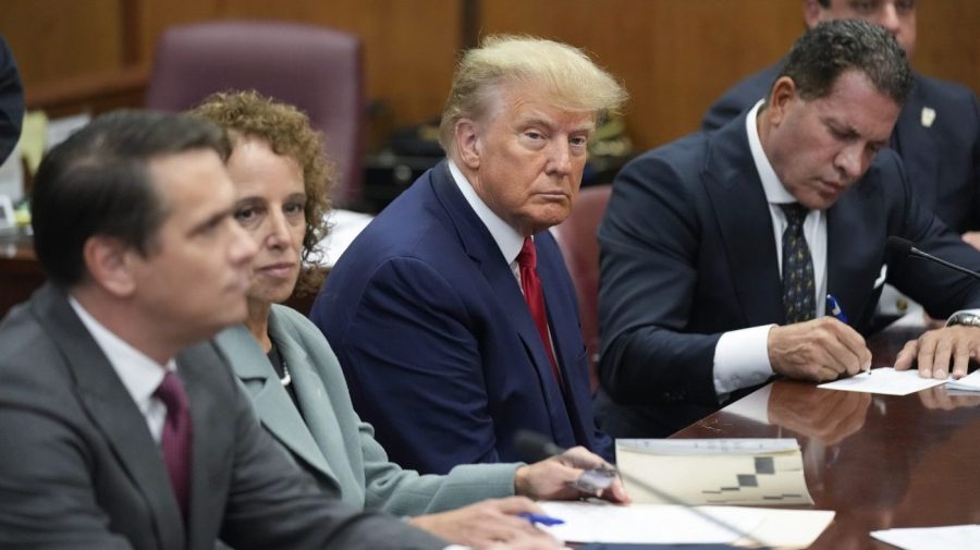 FILE - Former President Donald Trump sits at the defense table with his legal team in a Manhattan court, Tuesday, April 4, 2023, in New York. Trump appeared in court on charges related to falsifying business records in a hush money investigation, the first president ever to be charged with a crime. (AP Photo/Seth Wenig, Pool)