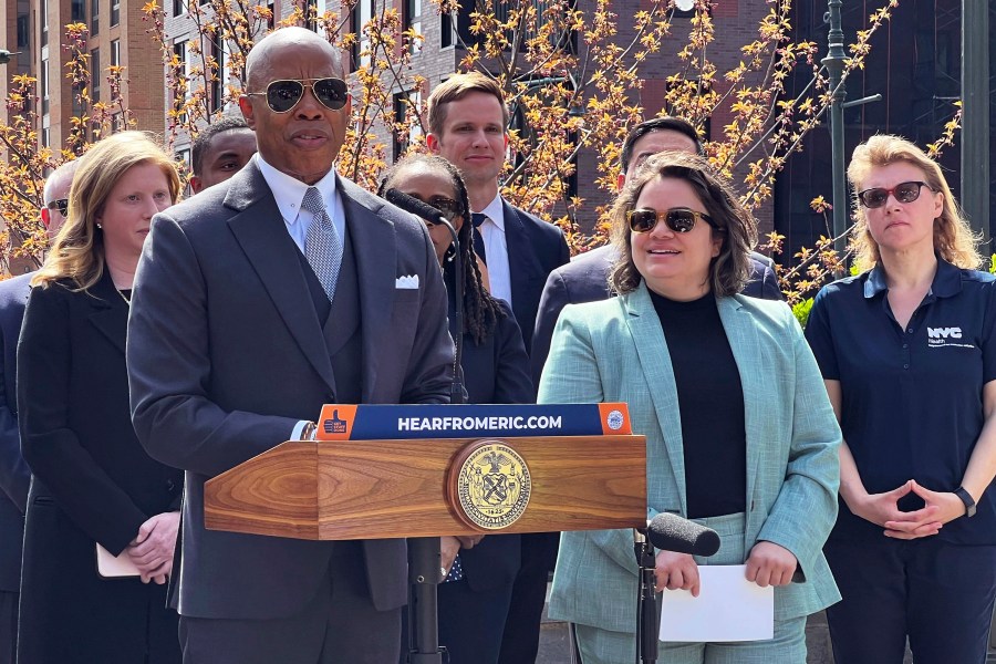 New York Mayor Eric Adams, left, introduces Kathleen Corradi, center, as the city's first-ever citywide director of rodent mitigation, also known as the "rat czar," in New York, Wednesday, April 12, 2023. (AP Photo/Bobby Caina Calvan)