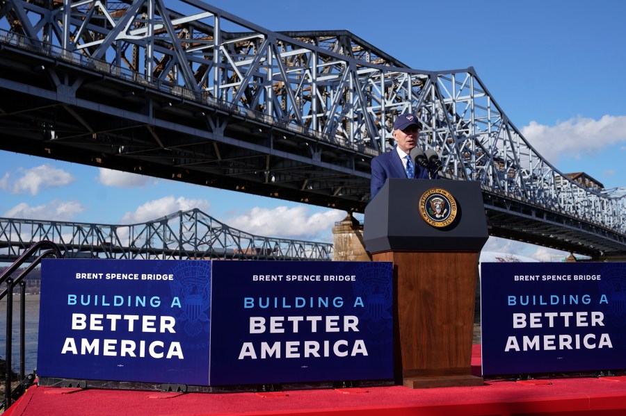 FILE - President Joe Biden speaks about his infrastructure agenda under the Clay Wade Bailey Bridge, Wednesday, Jan. 4, 2023, in Covington, Ky. The Biden administration is closing out a three-week push to highlight the benefits of infrastructure investments in local communities by awarding nearly $300 million to help repair or replace more than a dozen bridges across the country. Events in four states on Thursday, April 13, will mark the end of the beginning of a more expansive White House push heading into Biden's expected 2024 reelection race to remind voters of his accomplishments. (AP Photo/Patrick Semansky, File)