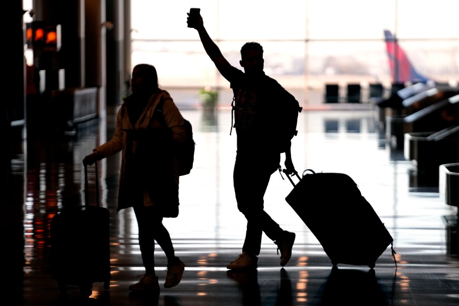 FILE - People pass through Salt Lake City International Airport on Jan. 11, 2023, in Salt Lake City. Federal officials said Thursday, April 13, 2023, that they have referred more than 250 unruly airline passengers to the FBI for possible criminal prosecution since late 2021, including one as recently as last month, when a man tried to stab a flight attendant with a broken-off spoon. (AP Photo/Rick Bowmer, File)