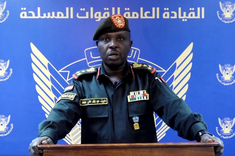 In this frame grab from a video posted by Sudan's state news agency, SUNA on Thursday, April 13, 2023, spokesman for the Sudanese Armed Forces Brig. Nabil Abdullah reads a statement warning of conflict after the recent deployment of Sudan's powerful paramilitary in the capital and other cities. Tensions between the military and the paramilitary, the Rapid Support Forces (RSF), have escalated in recent months, forcing a delay of the signing of an internationally-backed deal with political parties to restore the country's democratic transition. In the statement, the military said the buildup of the RSF in Khartoum and elsewhere in the country has come without "the approval of, or coordination with" the armed forces' leadership. (SUNA via AP)