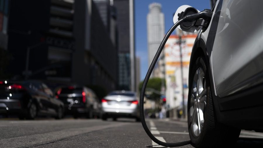 FILE - An electric vehicle is plugged into a charger in Los Angeles, Aug. 25, 2022. Ten electric or plug-in hybrid vehicles will be eligible for a $7,500 U.S. tax credit, while another seven could get $3,750 under new federal rules that go into effect on Tuesday, April 18, 2023. (AP Photo/Jae C. Hong, File)