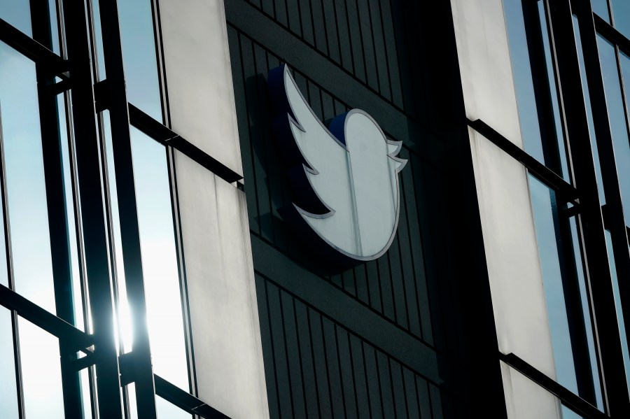 FILE - A Twitter logo hangs outside the company's offices in San Francisco, on Dec. 19, 2022. The Canadian Broadcasting Corporation paused its use of Twitter on Monday, April 17, 2023, after the social media platform owned by Elon Musk stamped CBC’s account with a label the public broadcaster says is intended to undermine its credibility. (AP Photo/Jeff Chiu, File)