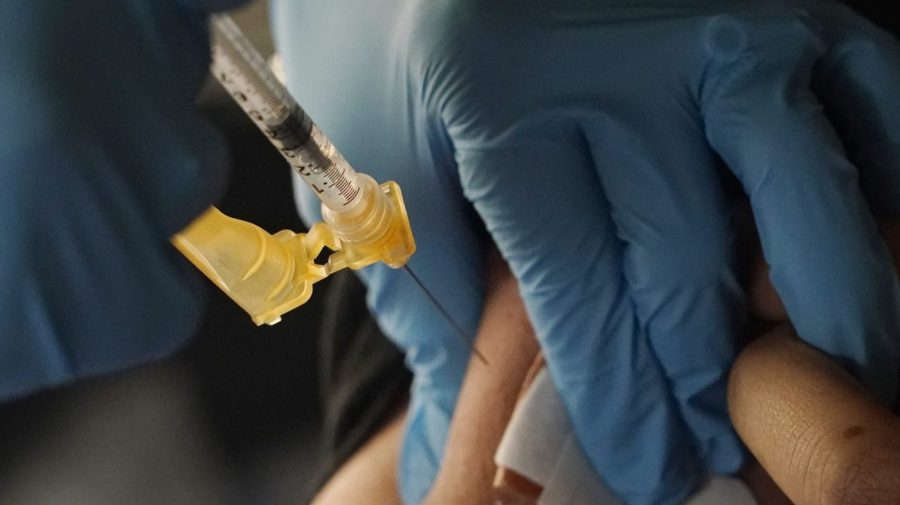 A nurse administers a Moderna COVID-19 booster vaccine at an inoculation station next to Jackson State University in Jackson, Miss., Friday, Nov. 18, 2022. U.S. regulators on Tuesday, April 18, 2023, cleared another COVID-19 booster dose for older adults and people with weak immune systems so they can shore up protection this spring — while taking steps to make coronavirus vaccinations simpler for everyone else.(AP Photo/Rogelio V. Solis)