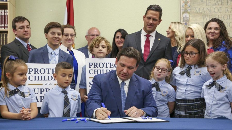 FILE - Florida Gov. Ron DeSantis signs the Parental Rights in Education bill at Classical Preparatory school on March 28, 2022, in Shady Hills, Fla. (Douglas R. Clifford/Tampa Bay Times via AP, File)