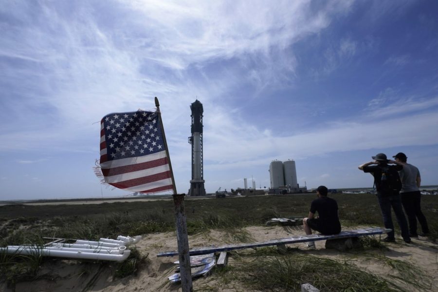 Onlookers watch as SpaceX's Starship, the world's biggest and most powerful rocket, stands ready for launch in Boca Chica, Texas, Sunday, April 16, 2023. (AP Photo/Eric Gay)