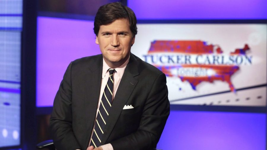 FILE - Tucker Carlson, host of "Tucker Carlson Tonight," poses for photos in a Fox News Channel studio on March 2, 2017, in New York. (AP Photo/Richard Drew, File)