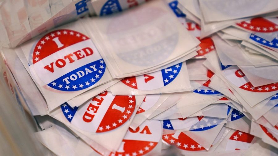 FILE - A bin of "I Voted Today" stickers rests on a table at a polling place, Sept. 13, 2022, in Stratham, N.H. A New Hampshire man who posted a fake Craigslist ad for a free trailer with a legislative candidate’s number on the day of the election has lost his right to vote in the state. Michael Drouin, 30, pleaded guilty Monday, April 24, 2023, to creating a false document after a flood of unwanted calls and texts jammed up the candidate's cell phone. (AP Photo/Charles Krupa, File)