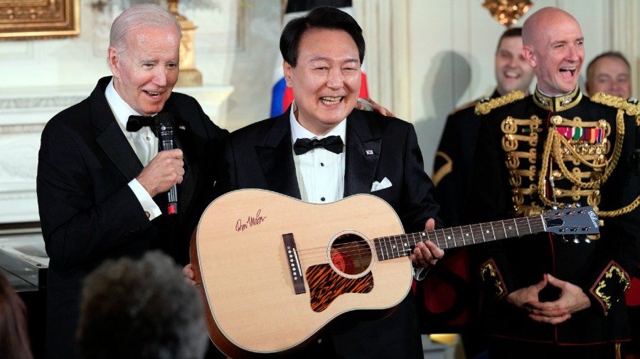 President Joe Biden surprises South Korea's President Yoon Suk Yeol with a guitar signed by Don McLean in the State Dining Room of the White House in Washington, Wednesday, April 26, 2023, following the State Dinner. American Pie, by McLean, is one of Yoon's favorite songs.