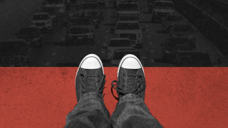 Photo illustration of a pedestrian standing (close-up of shoes and pants from above) on part of a red crosswalk overlooking a low-opacity, grayscaled photo of cars on the road