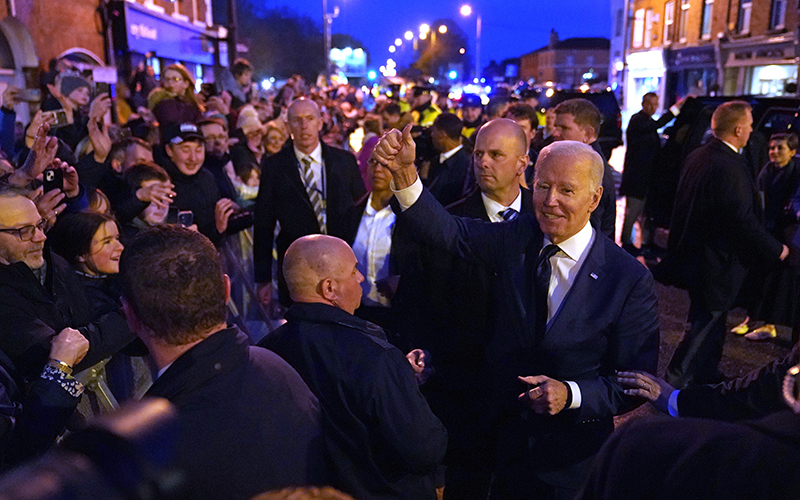 President Biden gives a thumbs up gesture to the crowd as he leaves after speaking at the Windsor Bar and Restaurant