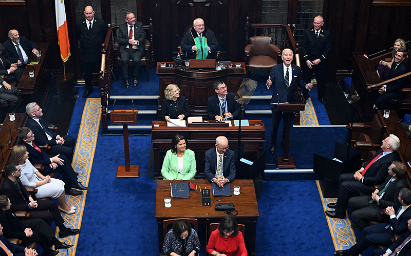 President Biden raises his hands as he arrives to deliver a speech at the lower house of the Irish Parliament
