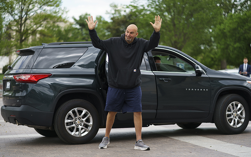 Sen. John Fetterman (D-Pa.) waves as he arrives to the Capitol