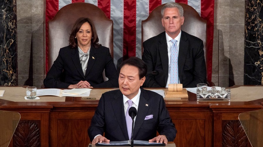 South Korean President Yoon Suk Yeol addresses a joint meeting of Congress, flanked by Vice President Harris and House Speaker Kevin McCarthy (R-Calif.) behind him