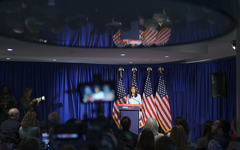 Republican presidential candidate Nikki Haley gives a policy speech in front of a background of American flags