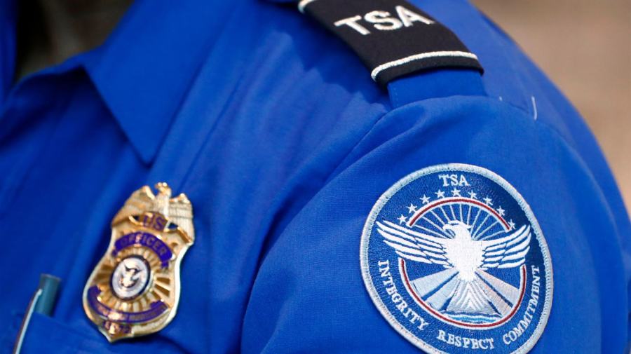 A TSA officer's uniform is shown in a closeup.