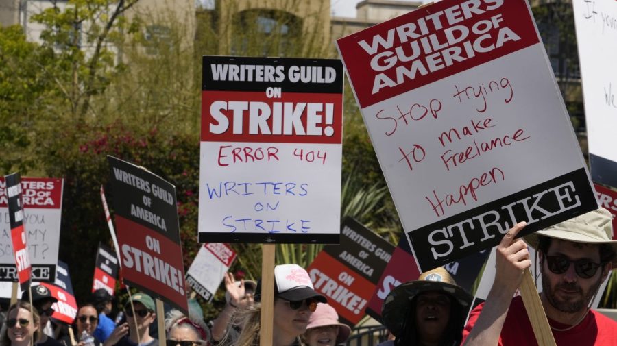 Members of the Writers Guild of America, WGA picket outside CBS Television City in the Fairfax District of Los Angeles Tuesday, May 2, 2023. The first Hollywood strike in 15 years began Tuesday as the economic pressures of the streaming era prompted unionized TV and film writers to picket for better pay outside major studios, a work stoppage that already is leading most late-night shows to air reruns. (AP Photo/Damian Dovarganes)