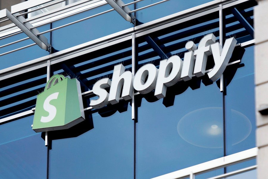 FILE - The company logo hangs on the Ottawa headquarters of Canadian e-commerce company Shopify, May 29, 2019.