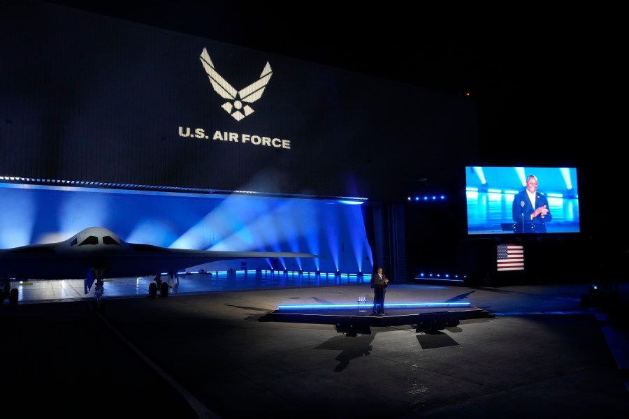 FILE - Secretary of Defense Lloyd Austin introduces the B-21 Raider stealth bomber at Northrop Grumman Dec. 2, 2022, in Palmdale, Calif. Under a proposed rule change, foreign citizens and companies would need U.S. government approval to buy property within 100 miles of eight military bases. The new rule would affect eight bases, including three that are tied to the B-21 Raider (AP Photo/Marcio Jose Sanchez, File)