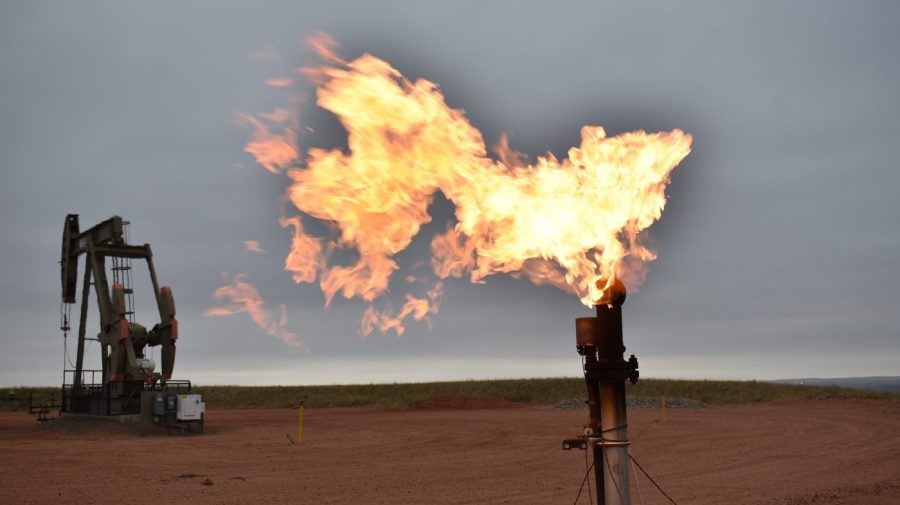 FILE - A flare burns natural gas at an oil well Aug. 26, 2021, in Watford City, N.D.