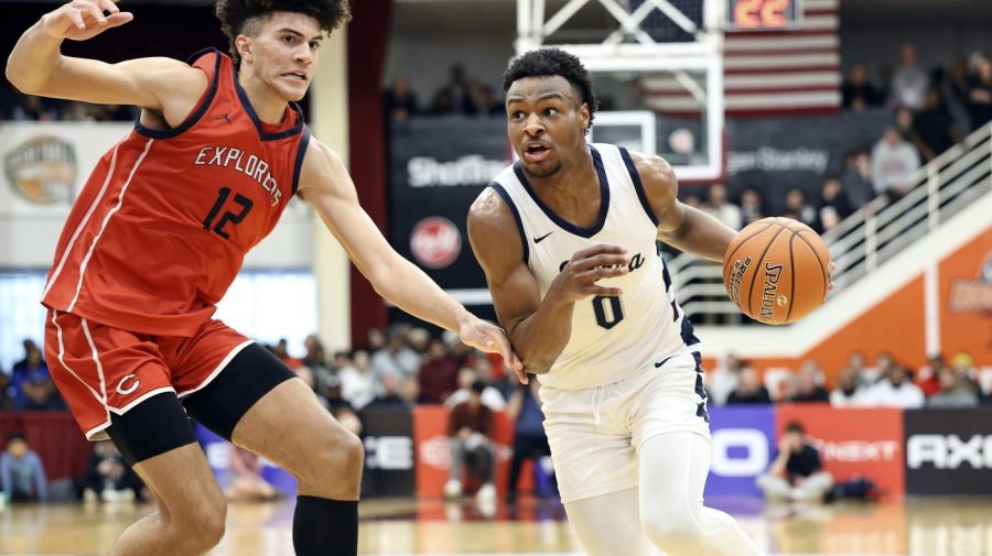 FILE -Sierra Canyon's Bronny James (0) drives against Christopher Columbus during a high school basketball game at the Hoophall Classic, Monday, Jan. 16, 2023, in Springfield, Mass. LeBron James' oldest son, Bronny, says he will play basketball at the University of Southern California in the fall. Bronny James abruptly announced his much-anticipated decision on social media Saturday, May 6, 2023. (AP Photo/Gregory Payan, File)