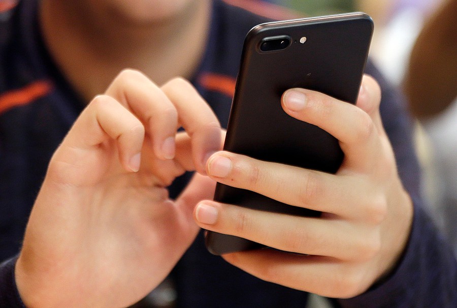 FILE - A person uses a smartphone in Chicago, Sept. 16, 2017. Most Democrats and Republicans agree that the federal government should better regulate the biggest technology companies, particularly social media platforms. But there is very little consensus on how it should be done. (AP Photo, File)