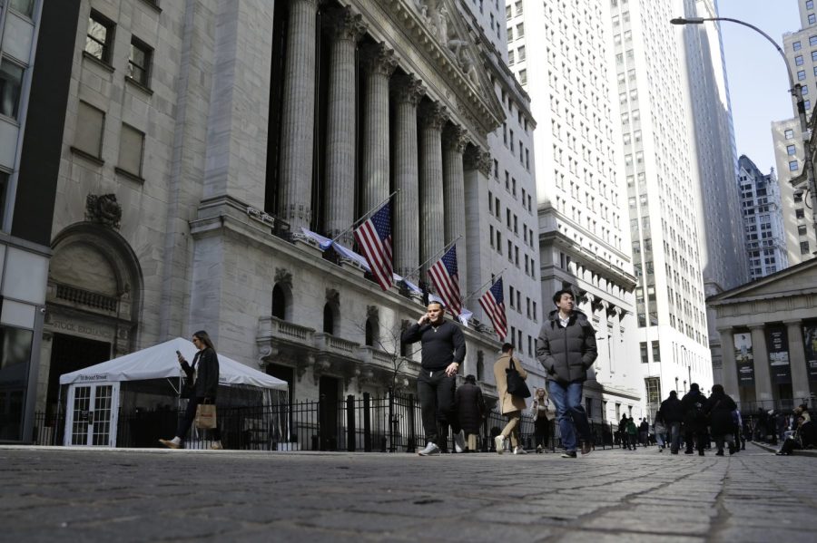 FILE - People pass the front of the New York Stock Exchange in New York, March 21, 2023. Stocks are dipping on Wall Street, Wednesday, April 5, and Treasury yields are dropping following the latest signals that the U.S. economy is slowing under the weight of much higher interest rates. (AP Photo/Peter Morgan, File)