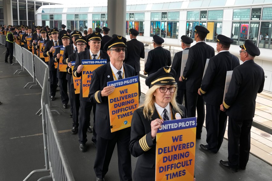 Members of the Air Line Pilots Association International walk an informational picket on behalf of United Airline pilots at O'Hare International Airport Friday, May 12, 2023, in Chicago. (AP Photo/Charles Rex Arbogast)