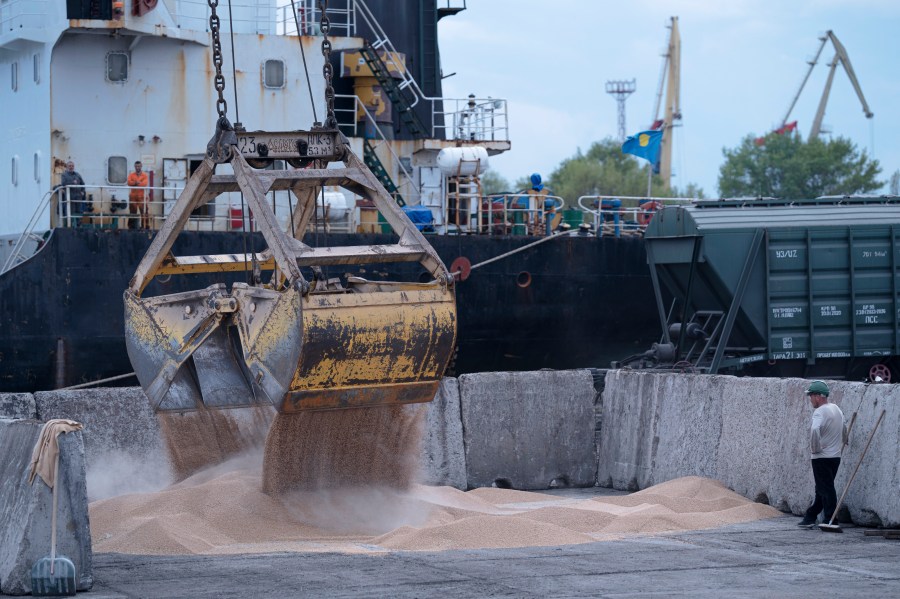 FILE - Workers load grain at a grain port in Izmail, Ukraine, on April 26, 2023. The United Nations is racing to extend a deal that has allowed for shipments of Ukrainian grain through the Black Sea to parts of the world struggling with hunger, helping ease a global food crisis exacerbated by the war that Russia launched more than a year ago. (AP Photo/Andrew Kravchenko, File)