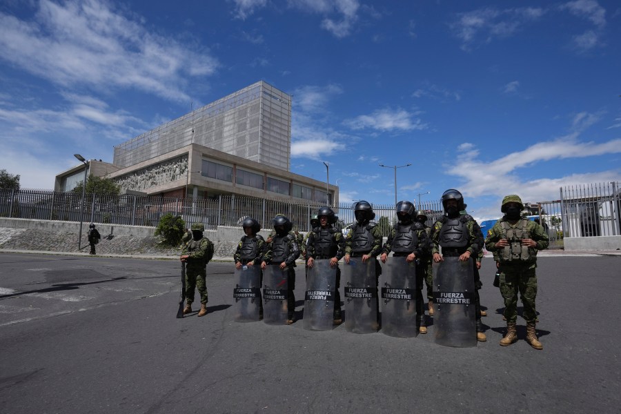 Soldiers stand guard outside the National Assembly the day after the body was disolved by President Guillermo Lasso in Quito, Ecuador, Thursday, May 18, 2023. Lawmakers were moving forward with impeachment proceedings against the president on embezzlement charges when he disolved it, and now residents are expected to elect a new president and a new lawmakers in no more than 90 days. (AP Photo/Dolores Ochoa)