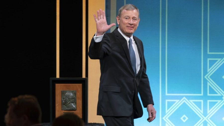 Supreme Court Chief Justice John Roberts waves to the crowd after he received the Henry J. Friendly Medal during the American Law Institute's annual dinner in Washington, Tuesday, May 23, 2023. (AP Photo/Jose Luis Magana)