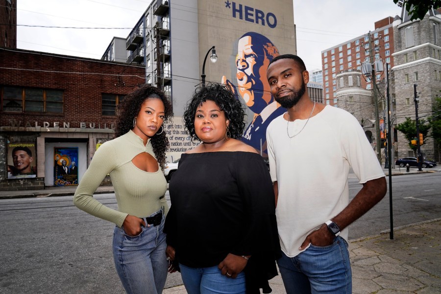 FILE - D'Zhane Parker, left, Cicley Gay, center, and Shalomyah Bowers pose for a portrait on May 13, 2022, in Atlanta. Black Lives Matter Global Network Foundation Inc., a national Black Lives Matter nonprofit, whose philanthropic fortunes grew almost overnight during historic racial justice protests three years ago, raised just over $9 million in its last fiscal year, new IRS tax filings show. Cicley Gay, board chair for the foundation, said the belt tightening was part of an effort to demonstrate that its stewards “have been responsible, proactive decision-makers of the people’s donations.” (AP Photo/Brynn Anderson, File)