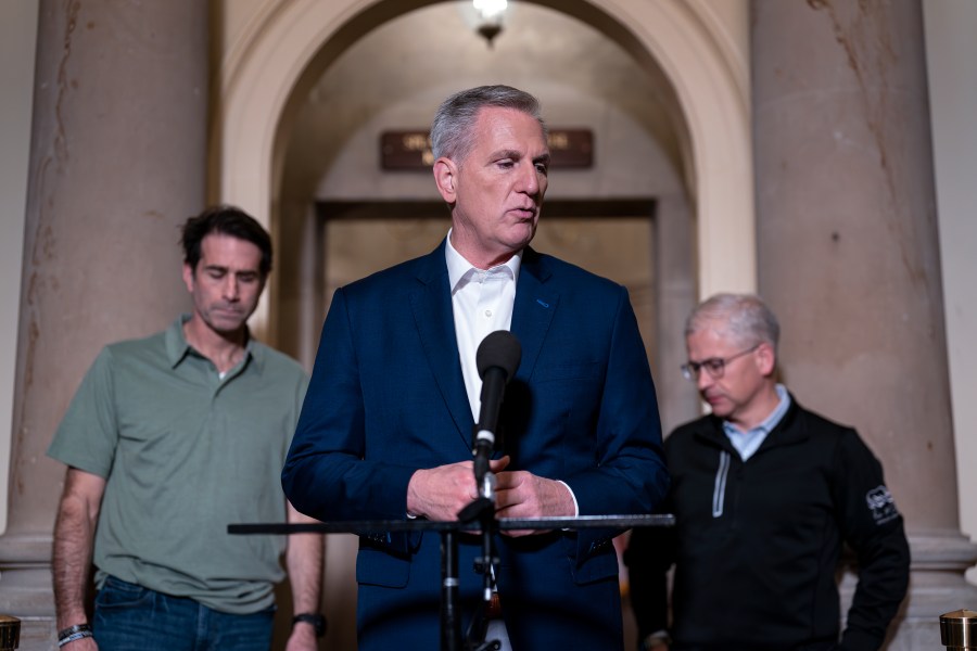 Speaker of the House Kevin McCarthy, R-Calif., flanked by his top negotiators on the debt limit, Rep. Garret Graves, R-La., left, and Rep. Patrick McHenry, R-N.C., chairman of the House Financial Services Committee, talks to reporters at the Capitol in Washington, Sunday, May 28, 2023. The mediators came to an "agreement in principle" with the White House that would avert a potentially disastrous U.S. default, but still has to pass both houses of Congress. (AP Photo/J. Scott Applewhite)