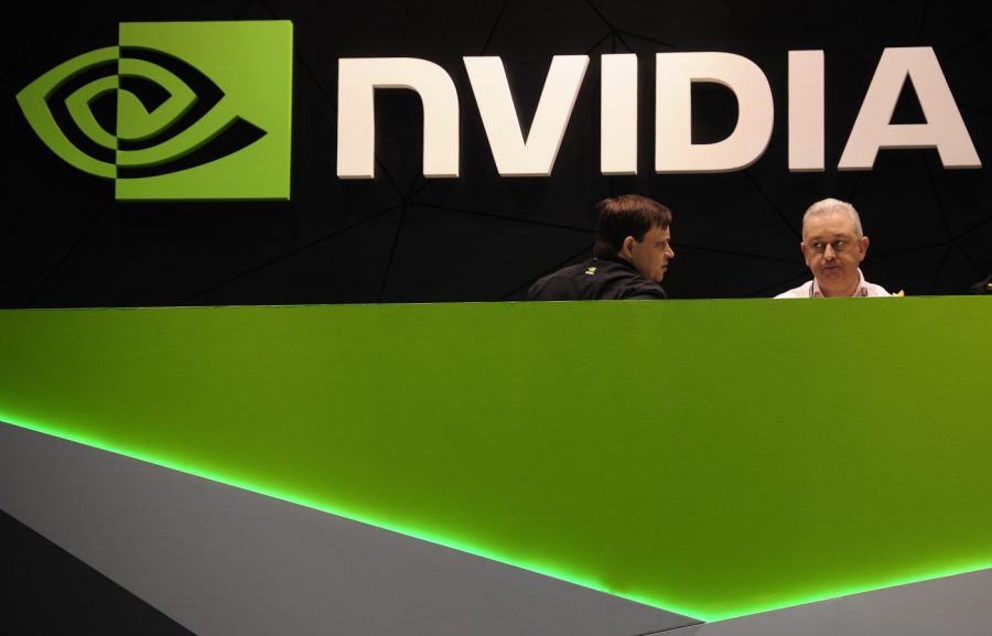 Two people engage at the Nvidia booth at a trade show.