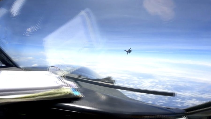 In this image from video provided by the U.S. Navy, a Chinese J-16 fighter flys aggressively close to a U.S. RC-135 aircraft flying in international airspace over the South China Sea on Friday, May 26, 2023. In a statement, U.S. Indo-Pacific Command said the Chinese J-16 fighter pilot "flew directly in front of the nose of the RC-135." It called the Chinese move an " unnecessarily aggressive maneuver." (U.S. Navy via AP)