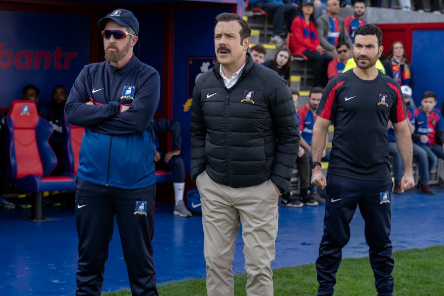 This image released by Apple TV shows Brendan Hunt, from left, Jason Sudeikis and Brett Goldstein in the season three finale episode of "Ted Lasso." (Colin Hutton/Apple TV via AP)