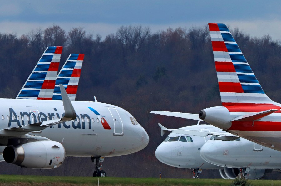 FILE - American Airlines planes are parked at Pittsburgh International Airport on March 31, 2020, in Imperial, Pa. American Airlines has reached a tentative labor agreement with pilots who recently raised the possibility of a strike against the nation’s biggest airline if they were unable to get a new contract with higher pay. American said Friday, May 19, 2023, that the four-year deal, if ratified by pilots, would give them pay and profit-sharing “that match the top of the industry.” (AP Photo/Gene J. Puskar, file)