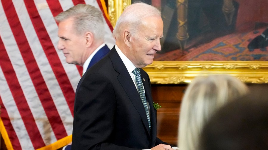 President Biden walks past Speaker Kevin McCarthy