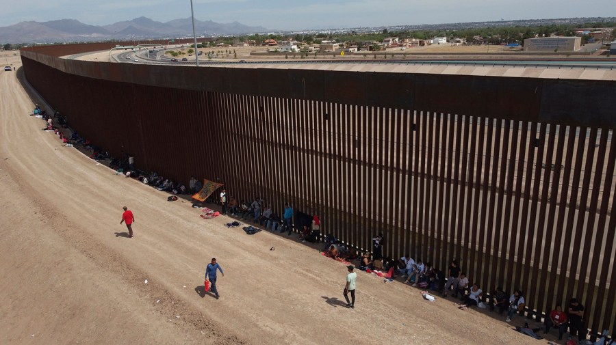 Migrants camp out next to the border barrier between El Paso, Texas and Ciudad Juárez, Mexico, Wednesday, May 3, 2023.