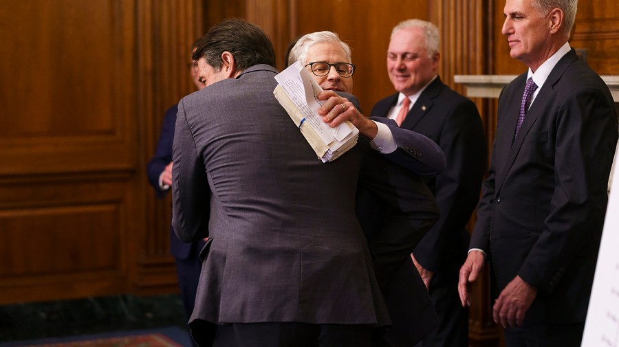 Rep. Garret Graves (R-La.) hugs Rep. Patrick McHenry (R-N.C.)