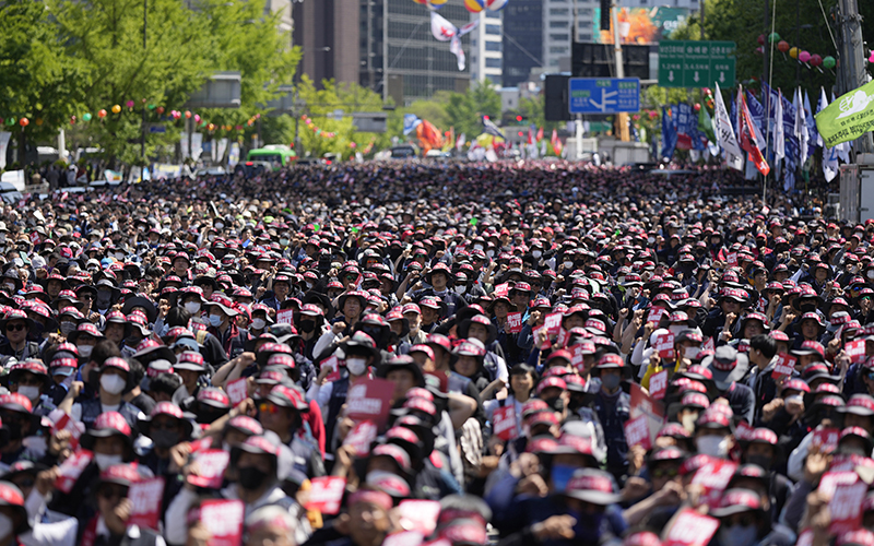 Members of the Korean Confederation of Trade Unions shout slogans during a rally