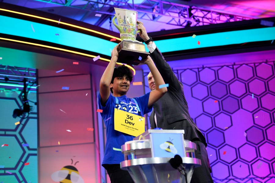 Dev Shah, 14, from Largo, Fla., lifts the trophy next to Scripps CEO Adam Symson after he won the Scripps National Spelling Bee finals, Thursday, June 1, 2023, in Oxon Hill, Md. (AP Photo/Nick Wass)