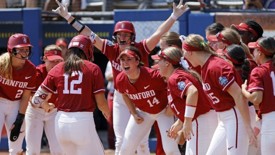 Stanford players celebrate as Kylie Chung (12) runs to home plate after hitting a home run against Oklahoma during the first inning of an NCAA softball Women's College World Series game Monday, June 5, 2023, in Oklahoma City. (AP Photo/Nate Billings)