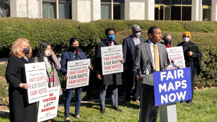 FILE - Reggie Weaver, at podium, speaks outside the Legislative Building in Raleigh, N.C, on Feb. 15, 2022, about a recent partisan gerrymandering ruling by the North Carolina Supreme Court. The U.S. Supreme Court ruled Thursday, June 8, 2023, that Alabama’s U.S. House districts violated the federal Voting Rights Act by diluting the political power of Black voters.(AP Photo/Gary D. Robertson, File)