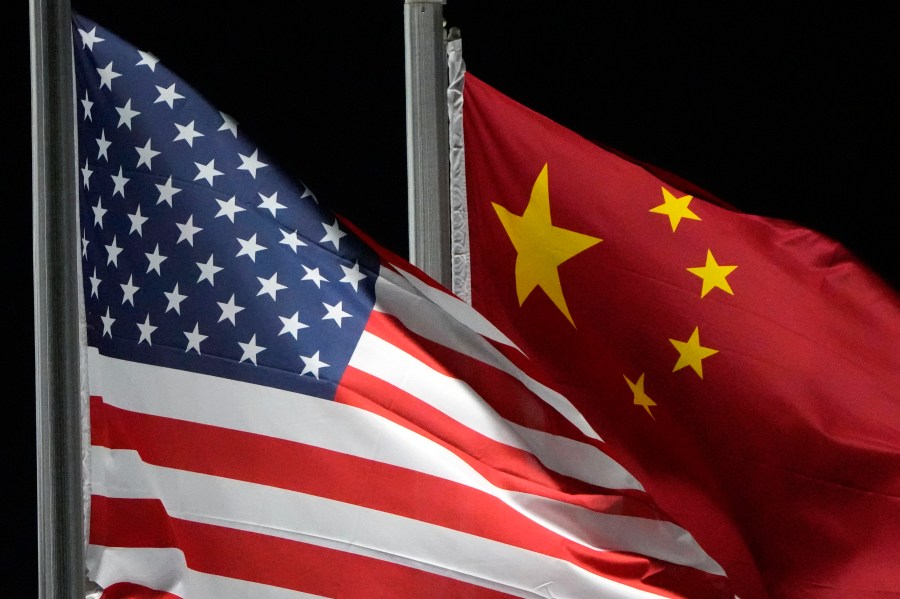 FILE - The American and Chinese flags wave at Genting Snow Park ahead of the 2022 Winter Olympics, Feb. 2, 2022, in Zhangjiakou, China. China has been operating a spy base in Cuba since at least 2019, as part of a global effort by Beijing to upgrade its intelligence capabilities. That's according to a Biden administration official who was not authorized to comment publicly and spoke on the condition of anonymity. (AP Photo/Kiichiro Sato, File)