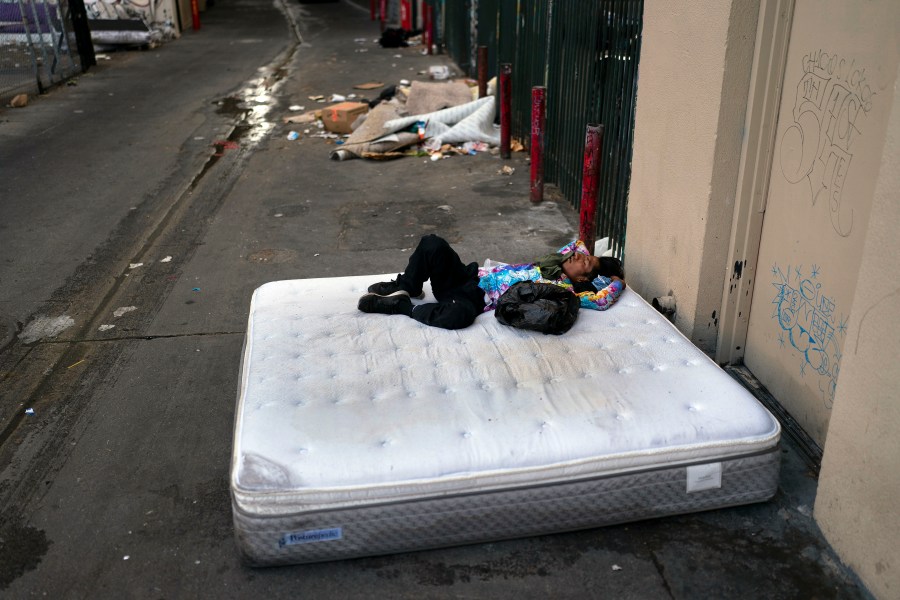 FILE - A homeless man sleeps on a discarded mattress in Los Angeles, July 21, 2022. Homeless people in California are already a vulnerable group, often struggling with poor health, trauma and deep poverty before they lose their housing, according to a new study on adult homelessness released Tuesday, June 20, 2023, by the University of California, San Francisco, aimed at capturing a comprehensive picture of how people become homeless in California. (AP Photo/Jae C. Hong, File)