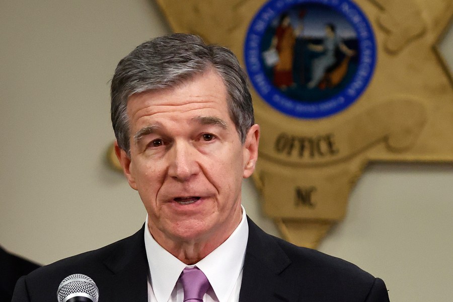 FILE - North Carolina Gov. Roy Cooper speaks at a news conference in Carthage, N.C., on Dec. 5, 2022. Transgender girls in North Carolina would no longer be allowed to play on the school sports teams that align with their gender identity under a proposal that received final legislative approval on Thursday, June 22, 2023. Cooper has little power to block it now that Republicans hold veto-proof majorities in both chambers of the General Assembly. (AP Photo/Karl B DeBlaker, File)